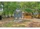 Backyard features mature trees, screened porch, and patio seating at 4546 Holly St, North Charleston, SC 29405