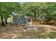 Well-maintained backyard with patio area, comfortable seating, a screen porch, and mature trees at 4546 Holly St, North Charleston, SC 29405