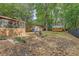 Spacious backyard features mature trees, sheds, a screened porch, and patio seating at 4546 Holly St, North Charleston, SC 29405