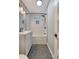 Well-lit bathroom with modern fixtures and stylish gray hexagon tile floor at 4546 Holly St, North Charleston, SC 29405