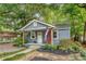 Cozy single-story home with a quaint front porch, manicured landscaping, and a welcoming American flag, reflecting pride at 4546 Holly St, North Charleston, SC 29405