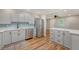 Stylish kitchen with stainless steel dishwasher, island and view to living room at 4546 Holly St, North Charleston, SC 29405