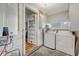 Clean laundry room with washer, dryer, and storage cabinets, well-lit with natural light at 4546 Holly St, North Charleston, SC 29405