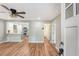 Bright open-concept living space with wood floors, leading into a modern kitchen and a hallway to the bathroom at 4546 Holly St, North Charleston, SC 29405