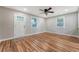 Open-concept living area with hardwood floors, white door and dual windows offering ample light at 4546 Holly St, North Charleston, SC 29405