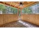 This screened porch features wood paneling, brick flooring, and a tropical-themed ceiling fan at 4546 Holly St, North Charleston, SC 29405