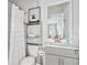 Well-lit bathroom featuring modern vanity, shower with curtain, toilet, mirror, and wall art at 4557 Mixson Ave, North Charleston, SC 29405