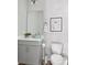 Elegant half-bath featuring a modern vanity, framed mirror, stylish fixtures and an artwork of penguins at 4557 Mixson Ave, North Charleston, SC 29405