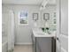 Well-lit bathroom with dual sinks, neutral tones, and framed wall art at 4557 Mixson Ave, North Charleston, SC 29405