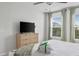 Bright bedroom with a dresser, television and window with tree views at 4557 Mixson Ave, North Charleston, SC 29405