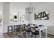 Bright dining room featuring modern chandelier, black accents, and an open layout with connecting living space at 4557 Mixson Ave, North Charleston, SC 29405
