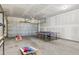 Spacious garage with a ping pong table, cornhole game, and ample room for vehicles at 4557 Mixson Ave, North Charleston, SC 29405