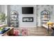Modern living room with sleek fireplace, wall-mounted TV, stylish decor, and light wood floors at 4557 Mixson Ave, North Charleston, SC 29405