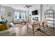 Bright living room with fireplace, featuring hardwood floors, ceiling fan, and stylish furniture at 4557 Mixson Ave, North Charleston, SC 29405
