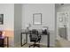 Home office area with sleek black desk, ergonomic chair, and view into an ensuite bathroom at 4557 Mixson Ave, North Charleston, SC 29405