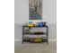 Multi-level black shelf features a selection of books, games, and novelties at 4557 Mixson Ave, North Charleston, SC 29405