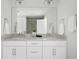 Bathroom features a double sink vanity, granite countertop, and a large mirror at 4585 Summey St, North Charleston, SC 29405
