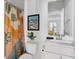 Bathroom features a floral shower curtain, white toilet and vanity with sink at 4585 Summey St, North Charleston, SC 29405