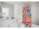 Bathroom with colorful shower curtain, white toilet and vanity with sink at 4585 Summey St, North Charleston, SC 29405