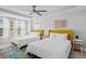 Bedroom with two twin beds, white bedding, and colorful patterned rug at 4585 Summey St, North Charleston, SC 29405