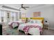 Bedroom with two twin beds, colorful throw blankets and floral pillows at 4585 Summey St, North Charleston, SC 29405