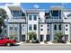 Contemporary townhome exterior featuring modern design and neutral color palette with a vibrant red pickup truck at 4585 Summey St, North Charleston, SC 29405
