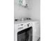 Modern laundry area featuring a washing machine and dryer with a wire rack for storage at 4585 Summey St, North Charleston, SC 29405