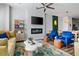 Open-concept living room featuring a fireplace, modern seating, and stylish decor elements at 4585 Summey St, North Charleston, SC 29405