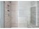 Modern shower featuring sleek tile, glass door, and a convenient built-in bench at 4585 Summey St, North Charleston, SC 29405