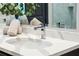 A modern bathroom sink with a stainless steel faucet, white countertop, and decorative towels at 5 Gadsdenboro St # 204, Charleston, SC 29401