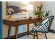 Close-up of an organized desk featuring a lamp, a globe, and a comfortable chair at 5 Gadsdenboro St # 204, Charleston, SC 29401