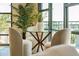 Bright dining area with a glass table, comfortable seating, plants, and lots of natural light at 5 Gadsdenboro St # 204, Charleston, SC 29401