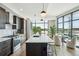 Sleek kitchen with stainless steel appliances, marble countertops, and an eat-in island with pendant lighting at 5 Gadsdenboro St # 204, Charleston, SC 29401