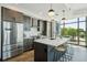 Gourmet kitchen featuring stainless steel appliances, dark wood cabinets, and a large island with bar seating at 5 Gadsdenboro St # 204, Charleston, SC 29401