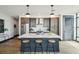 A modern kitchen with stainless steel appliances, dark wood cabinets, and an island with bar stool seating at 5 Gadsdenboro St # 204, Charleston, SC 29401