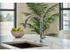 A sleek, chrome kitchen faucet and a white marble countertop with decor at 5 Gadsdenboro St # 204, Charleston, SC 29401