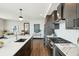 Modern kitchen featuring quartz countertops, stainless steel appliances, and an island with bar seating at 5 Gadsdenboro St # 204, Charleston, SC 29401