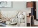 Comfortable living room with a white sofa, side table with lamp, and throw blanket at 5 Gadsdenboro St # 204, Charleston, SC 29401