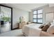 Bright main bedroom featuring neutral decor, a large window with water view, and wood dresser at 5 Gadsdenboro St # 204, Charleston, SC 29401