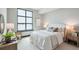 Inviting main bedroom with natural light from the large window and neutral décor at 5 Gadsdenboro St # 204, Charleston, SC 29401