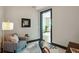Bright office with a comfortable armchair, a stylish lamp, and an open door to another room at 5 Gadsdenboro St # 204, Charleston, SC 29401