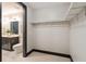 Bright walk-in closet leads to a bathroom with marble counters and floors and a modern sink and mirror at 5 Gadsdenboro St # 204, Charleston, SC 29401