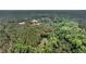Aerial view of the property nestled among lush trees, creating a sense of privacy and natural beauty at 5056 Red Oak Rd, Cottageville, SC 29435