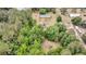 Aerial shot shows a property amidst dense trees, providing a sense of seclusion and natural beauty at 5056 Red Oak Rd, Cottageville, SC 29435