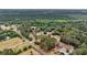 A birds-eye view reveals a plot and neighborhood, nestled within nature's embrace, highlighting the property's location and appeal at 5056 Red Oak Rd, Cottageville, SC 29435