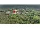 An aerial view of a property surrounded by a dense forest with varying shades of green and scattered clearings at 5056 Red Oak Rd, Cottageville, SC 29435