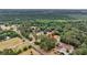 Overhead view showcasing the property with surrounding trees, road access, and a glimpse of the vast landscape at 5056 Red Oak Rd, Cottageville, SC 29435