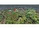 Aerial shot displays a home among lush, green surroundings, showcasing a tranquil, private setting at 5056 Red Oak Rd, Cottageville, SC 29435