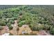 Aerial shot captures the property's layout, showcasing the buildings, and surrounding green landscape at 5056 Red Oak Rd, Cottageville, SC 29435