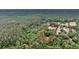 The aerial view showcases the property with lush greenery, established trees, and a long driveway to the house at 5056 Red Oak Rd, Cottageville, SC 29435